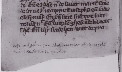 A medieval manuscript page showing gothic script with a critique written below in a different hand